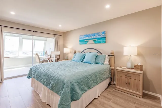 a bedroom with a bed and a large window