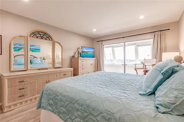 a bedroom with a large bed and a large window