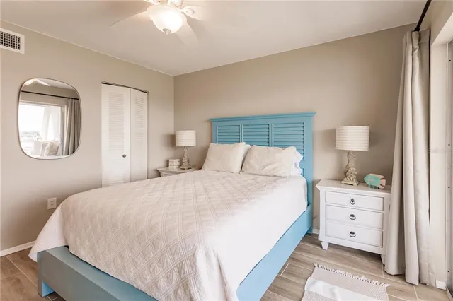 a bedroom with a large bed and a mirror