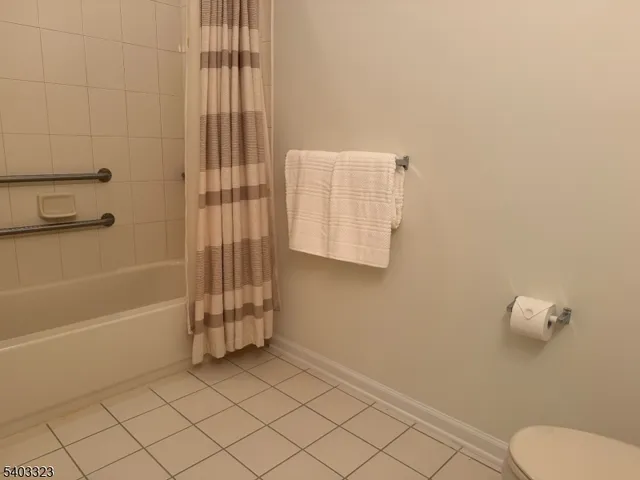 a living room with furniture kitchen view and a chandelier