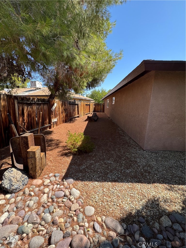 209 Kimberly Lane Ridgecrest, CA 93555 - Photo 10 of 62 a view of a backyard with a sitting area