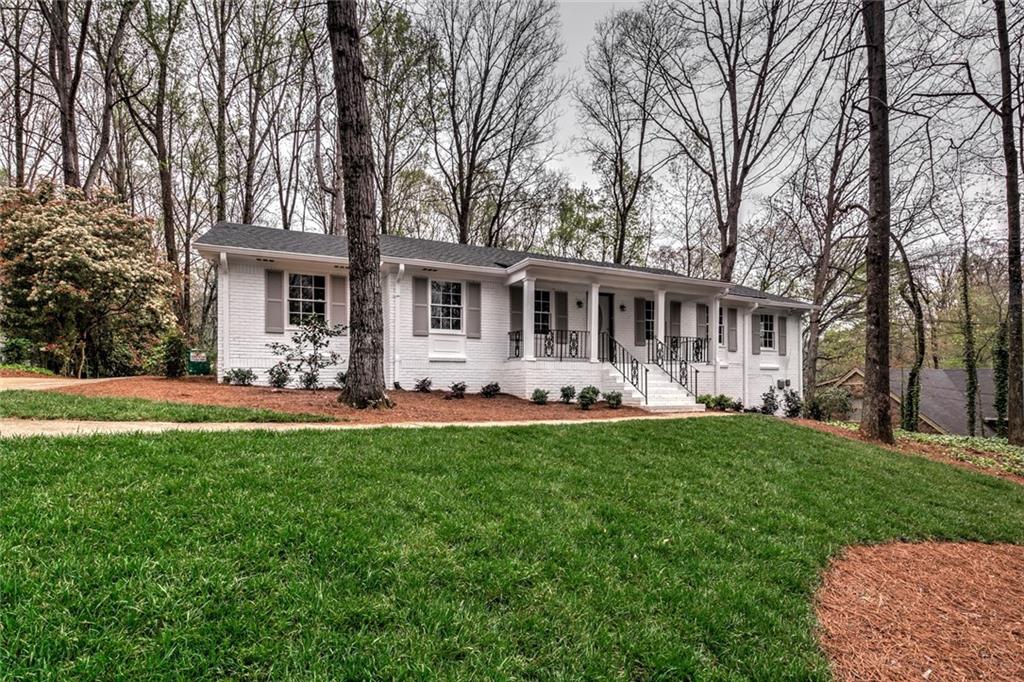 White painted 4-sided brick ranch with new architectural shingle roof. Beautiful new landscaping with sod and fresh shrub plantings.Driveway wraps around to the back of the house.