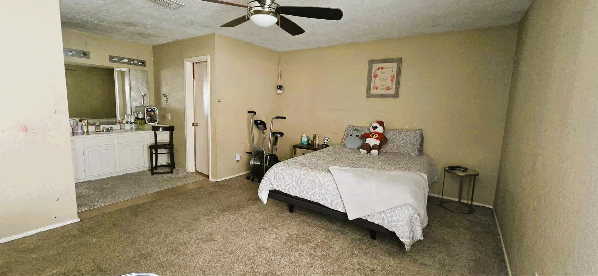2303 Spring Dusk Drive Spring, TX 77373 - Photo 11 of 13 a bedroom with a bed and a chandelier
