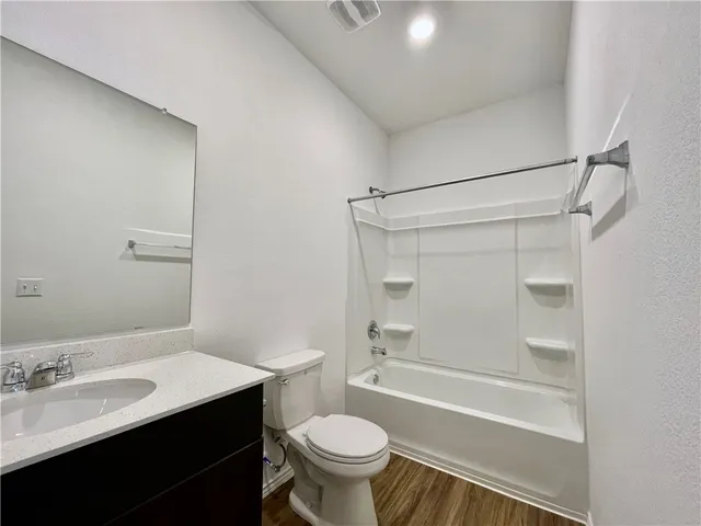 a bathroom with a sink toilet vanity and shower