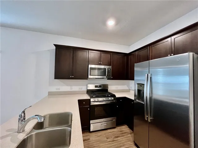 a kitchen with a refrigerator sink and microwave