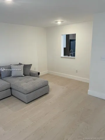 a living room with furniture and a wall painting