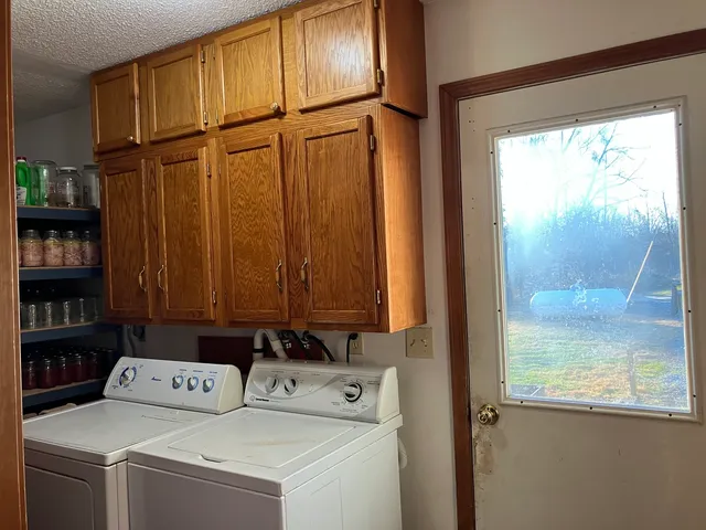 a view of storage and utility room with washer and dryer