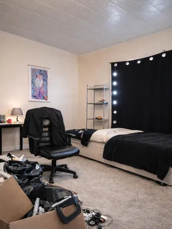 a bedroom with a bed and a couch