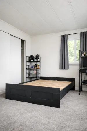 a spacious bedroom with a bed and a window