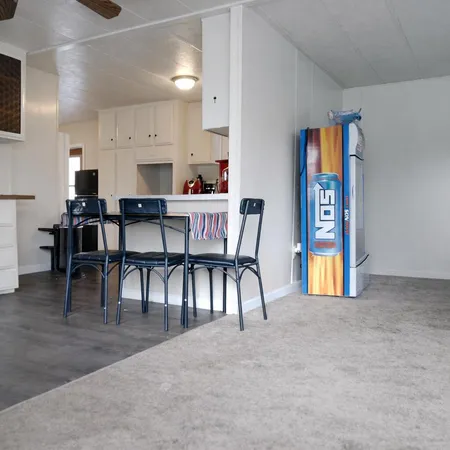 a view of a dining room with furniture and a kitchen