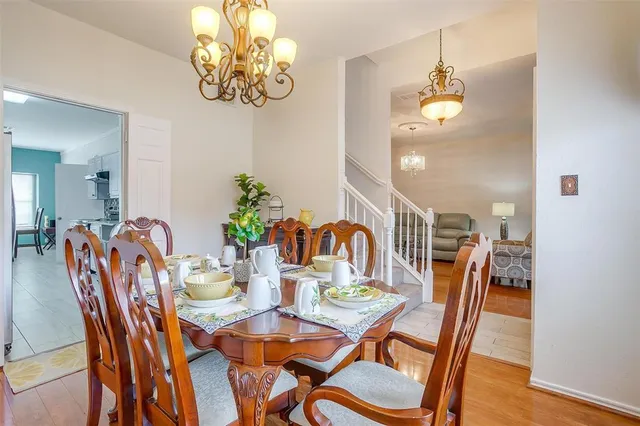 a view of a dining room with furniture and chandelier