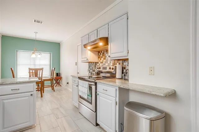 a kitchen with a sink cabinets and wooden floor