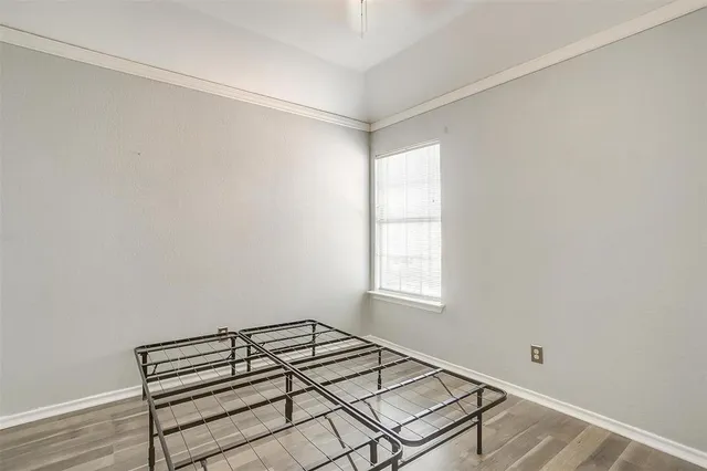 a view of a room with wooden floor and windows