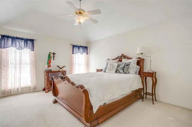 a bed sitting in a bedroom next to a window