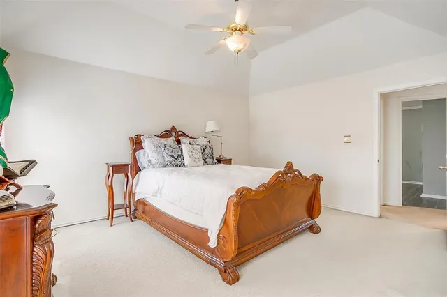 a bed sitting in a bedroom and chandelier