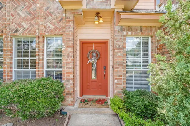 a front view of a house with large windows