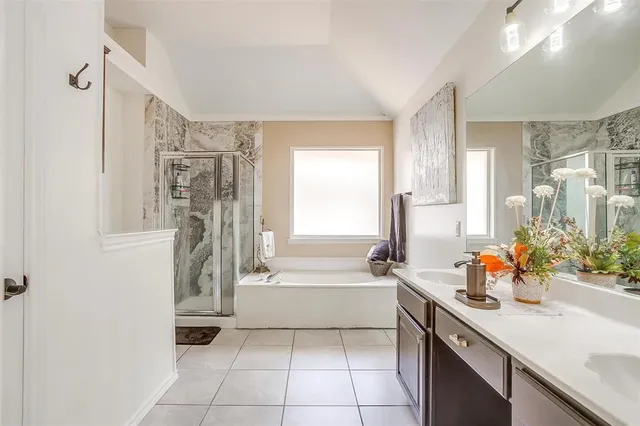 a spacious bathroom with a sink mirror vanity and bathtub