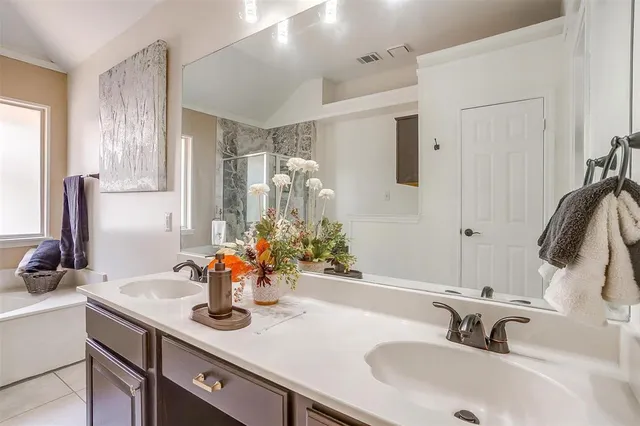 a bathroom with a sink double vanity and a mirror