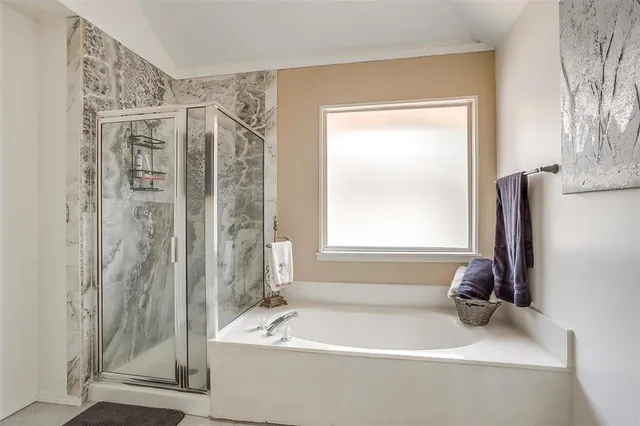 a bathroom with a tub shower and a sink