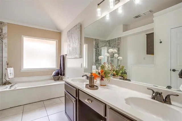 a bathroom with a tub sink and mirror