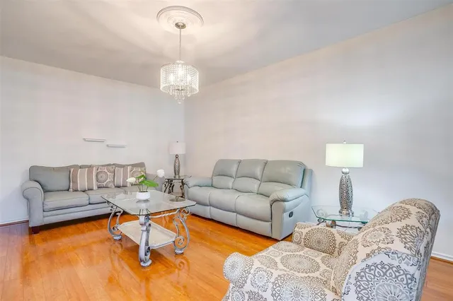a living room with furniture a couch and a chandelier