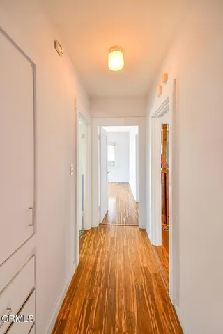 a view of a bedroom with wooden floor and bathroom