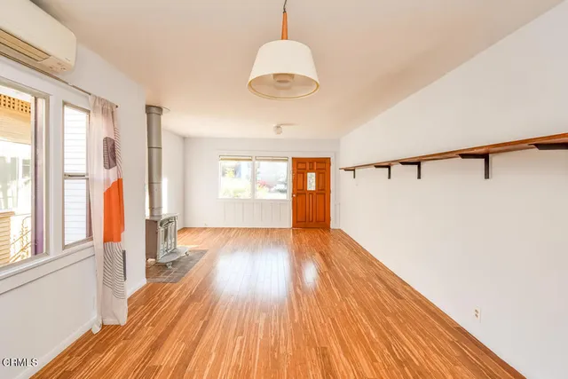 a view of a room with wooden floor and window