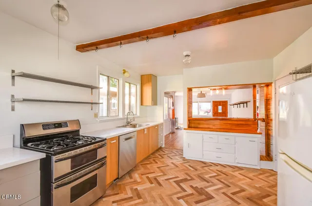 a kitchen with stainless steel appliances a sink and a stove