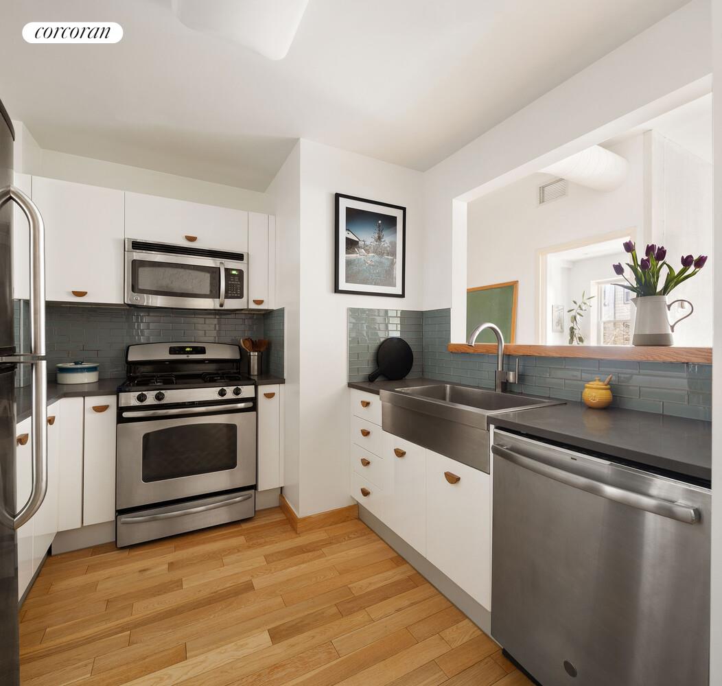 794 Hart Street, Unit 2B Brooklyn, NY 11237 - Photo 2 of 7 a kitchen with granite countertop a sink and a stove top oven
