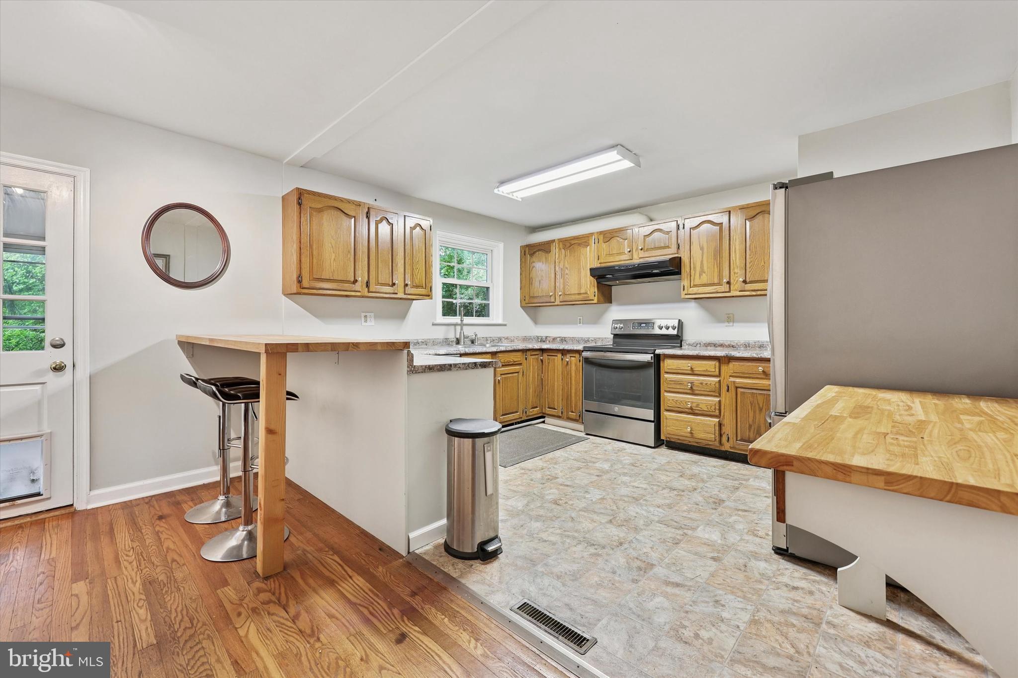 2107 Church Road Flourtown, PA 19031 - Photo 7 of 25 a kitchen with kitchen island stainless steel appliances a stove top oven a sink a counter space and cabinets