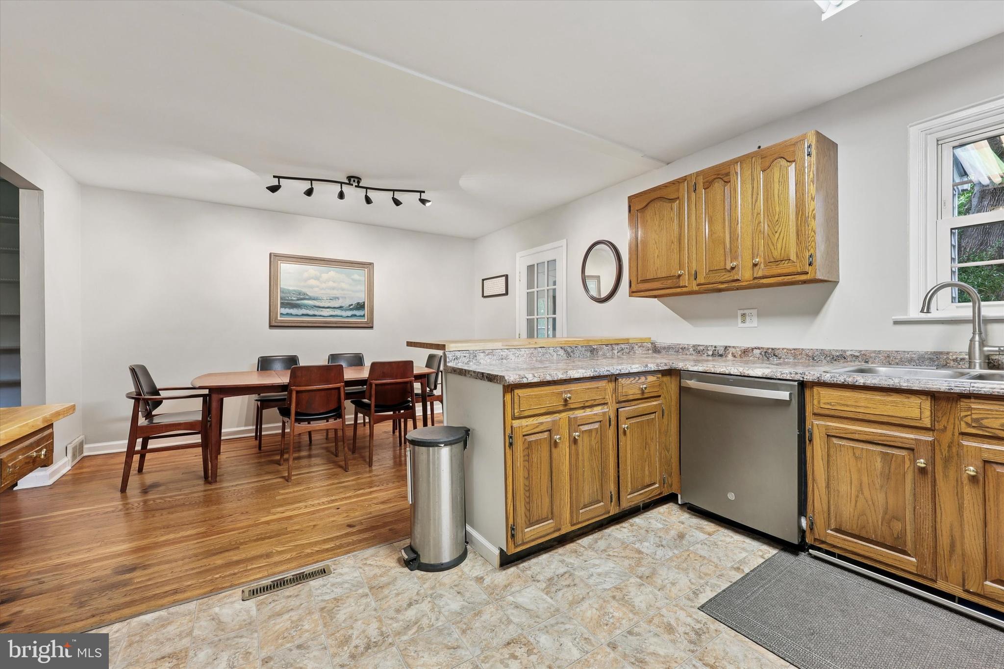 2107 Church Road Flourtown, PA 19031 - Photo 8 of 25 a kitchen with stainless steel appliances granite countertop a stove top oven a sink a dining table and chairs