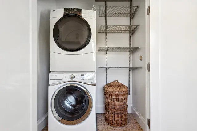 a bedroom with a bed a couch and a window