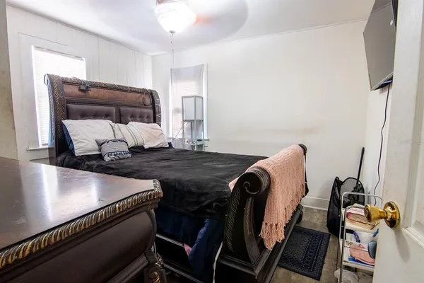 a bedroom with a bed and a large mirror
