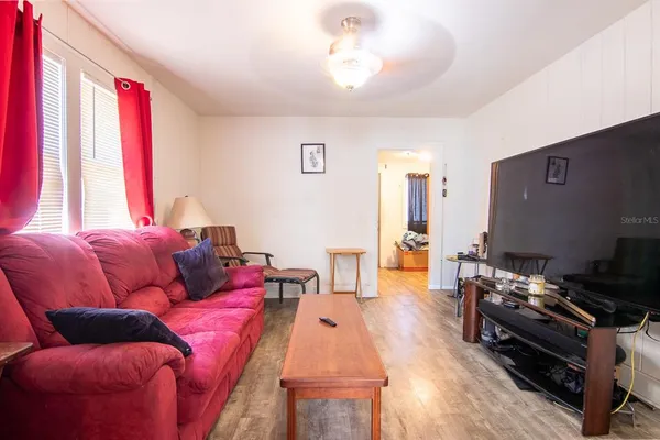 a living room with furniture and a flat screen tv