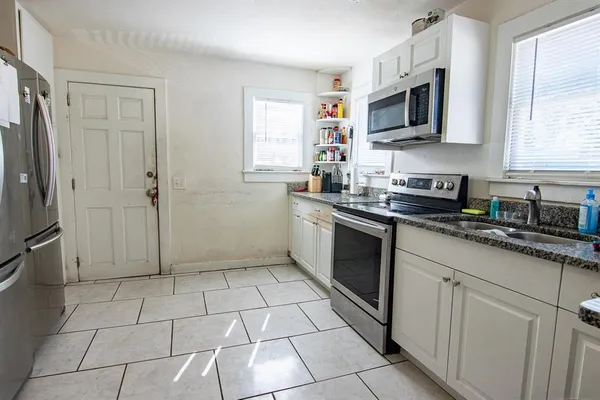 a kitchen with stainless steel appliances a sink a stove a microwave and cabinets