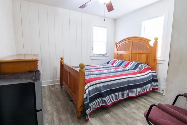 a bedroom with bed and a chandelier
