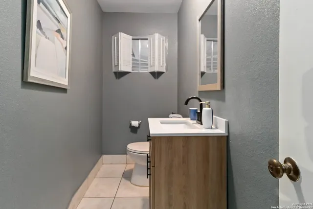 a bathroom with a sink toilet and mirror