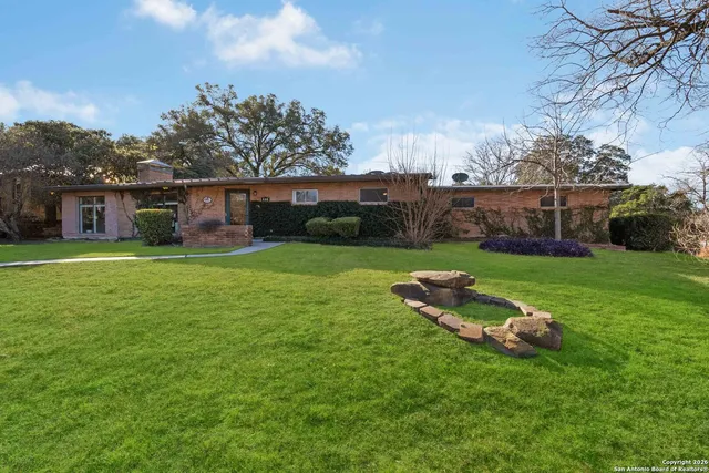 a view of a house with a yard and sitting area