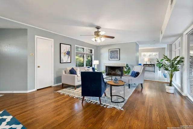 a living room with furniture a fireplace and a window