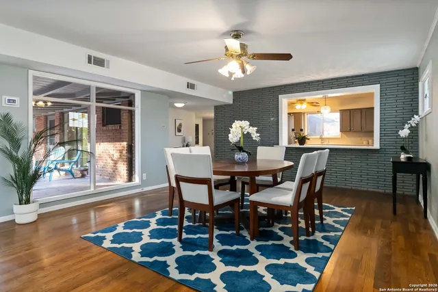 a view of a dining room with furniture and wooden floor