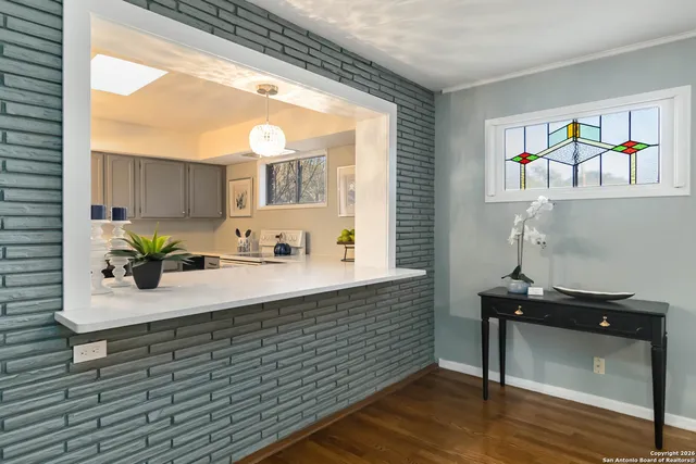a bathroom with a sink a mirror and a window