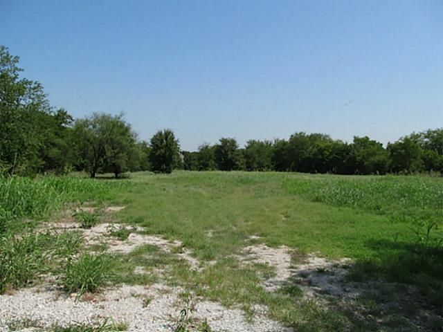 2809 Turner Warnell Road Arlington, TX 76001 - Photo 2 of 26 a view of a green field with wooden fence