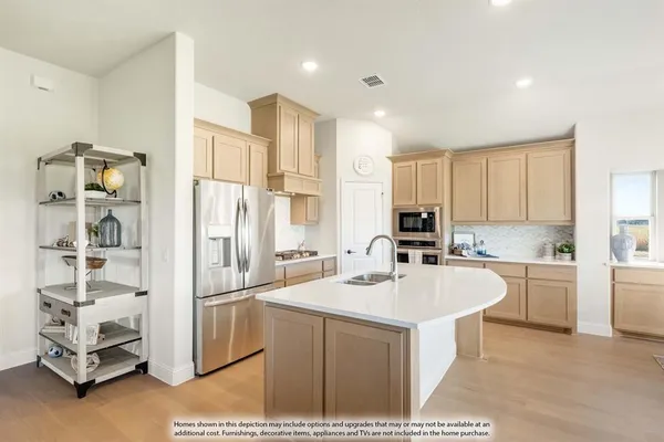 a kitchen with a sink refrigerator and cabinets