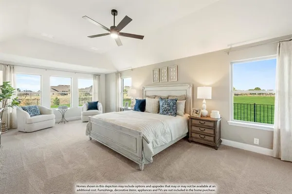 a spacious bedroom with a bed and a couch