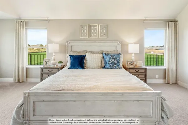 a bedroom with a bed and a large window with outer view