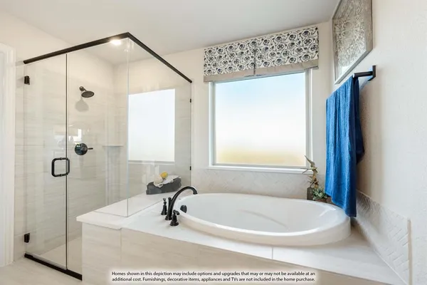 a white bath tub sitting next to a white sink