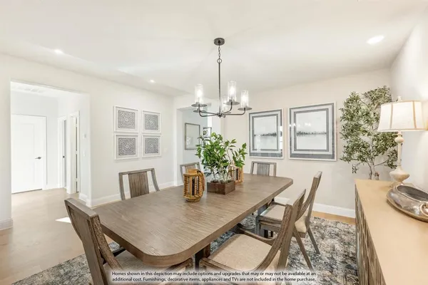 a dining room with furniture a chandelier and wooden floor