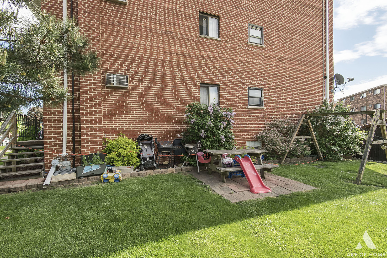 5731 106th Street Chicago Ridge, IL 60415 - Photo 5 of 25 a view of a backyard with plants and a slide