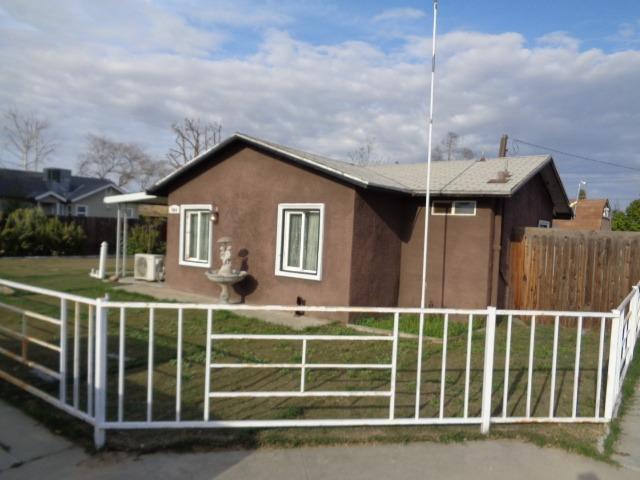 1084 Cyrier Avenue Reedley, CA 93654 - Photo 11 of 11 a front view of a house with a garden