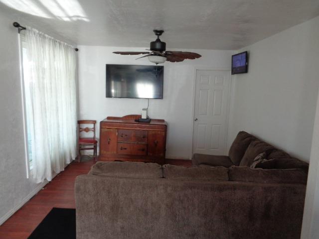 1084 Cyrier Avenue Reedley, CA 93654 - Photo 3 of 11 a living room with furniture and a flat screen tv